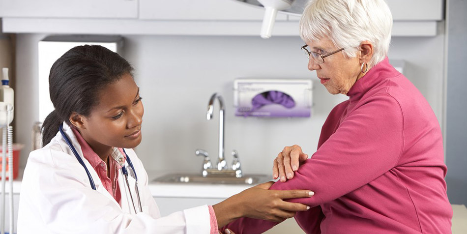 A doctor examines a patient with elbow joint pain.