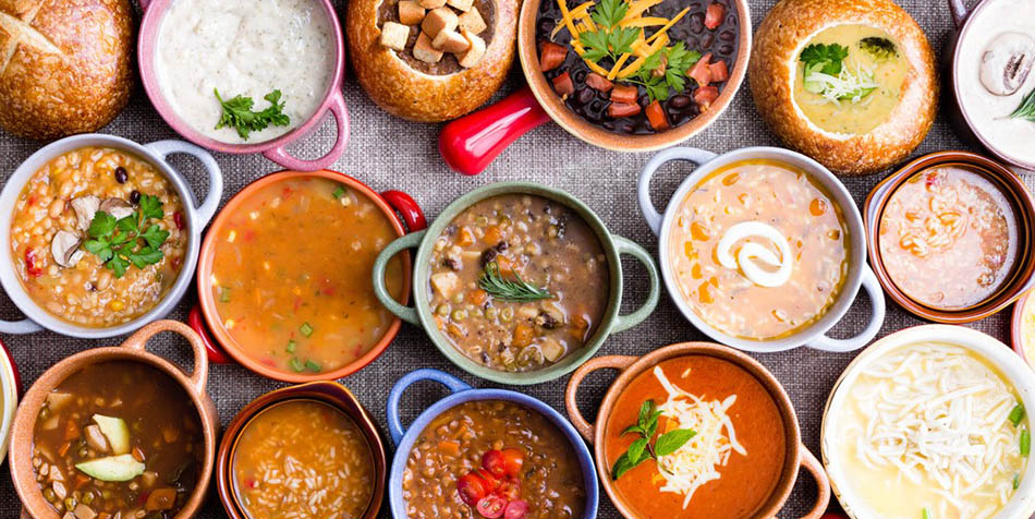 Assortment of soups on a table.