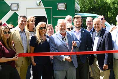 Hospital leaders cut a ribbon for the new ambulance